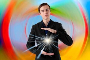 Young man holding light between his hands, with a thoughtful expression: insight and energy